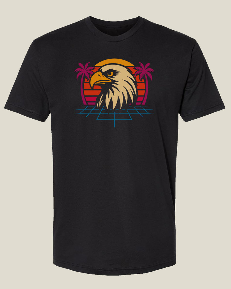 Black t-shirt with an 80's style eagle head graphic in front of a sunset with palm trees and retro blue grid