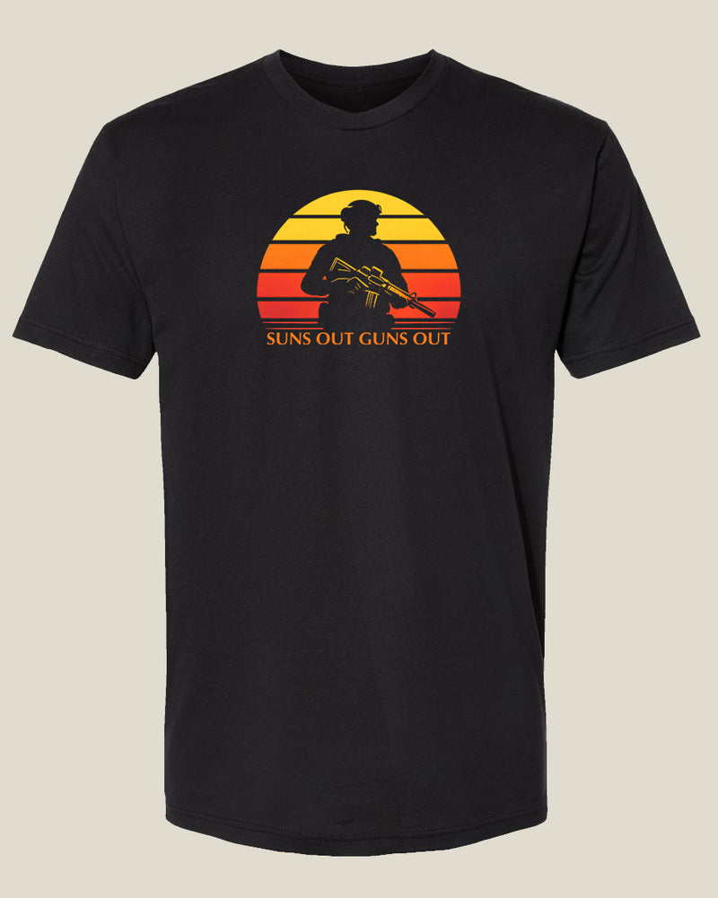 black t-shirt with yellow, orange, and red retro sun with cutout of a man in uniform holding a rifle with text: "Suns Out Guns Out" underneath