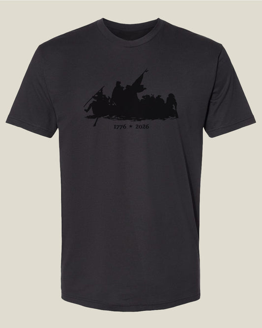 Graphite black t-shirt with a graphic design depicting the Crossing of the Delaware with text 1776-2026