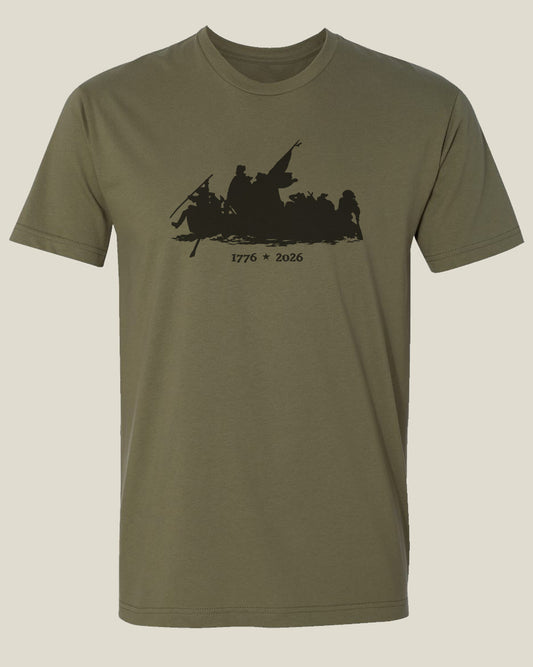 Olive drab t-shirt with a graphic design depicting the Crossing of the Delaware with text 1776-2026