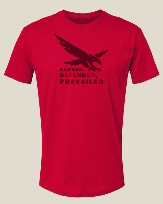 Red t-shirt with an eagle graphic and text 'Earned, Defended, Prevailed'