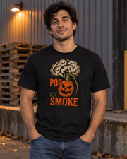 Man wearing the black Jack O Smoke T-Shirt in a realistic Halloween lifestyle scene.
