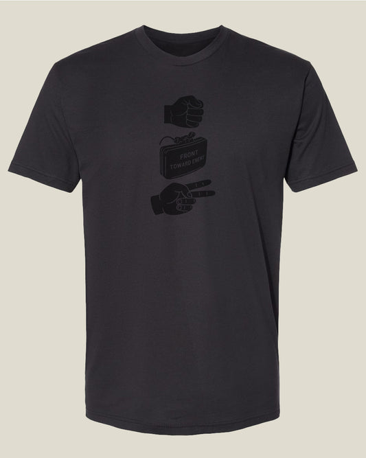Graphite black t-shirt with hand and Claymore explosive graphics depicting 'Rock, Claymore, Scissors'