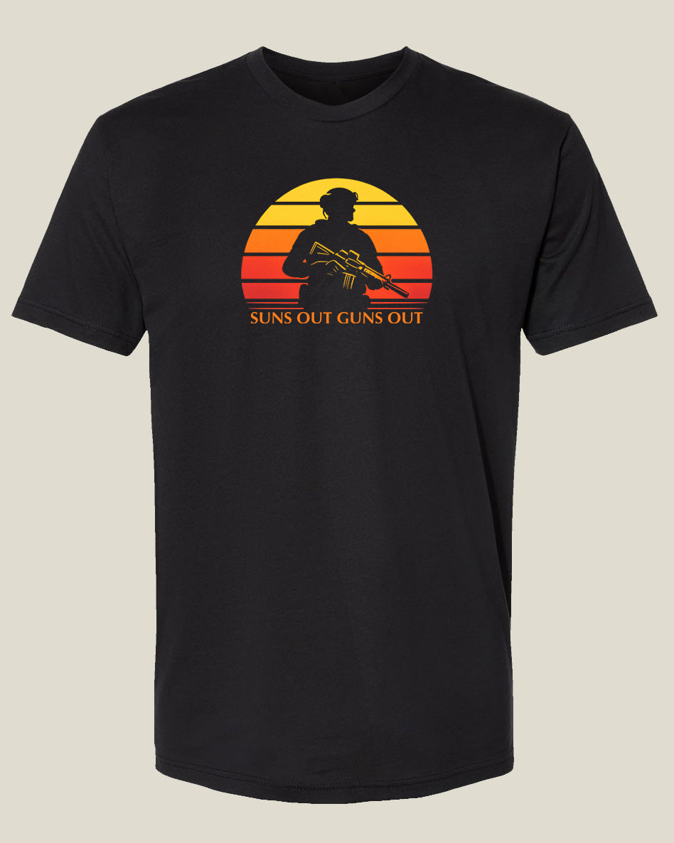 black t-shirt with yellow, orange, and red retro sun with cutout of a man in uniform holding a rifle with text: "Suns Out Guns Out" underneath