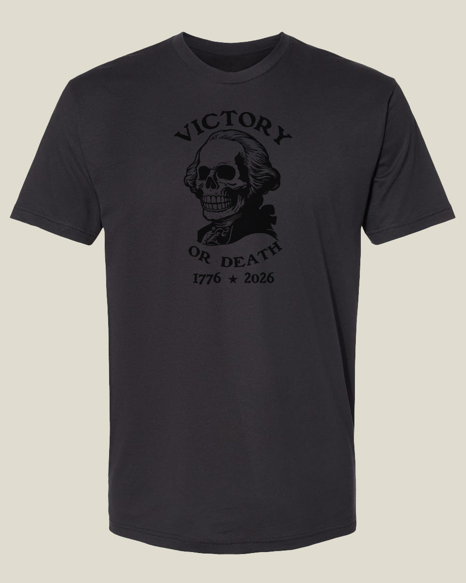 Graphite black cotton t-shirt with a graphic design featuring a George Washington skull and text 'Victory or Death' and '1776-2026'